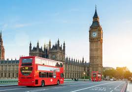 Great Bell of the Great Clock of Westminster and double decker busses on the road